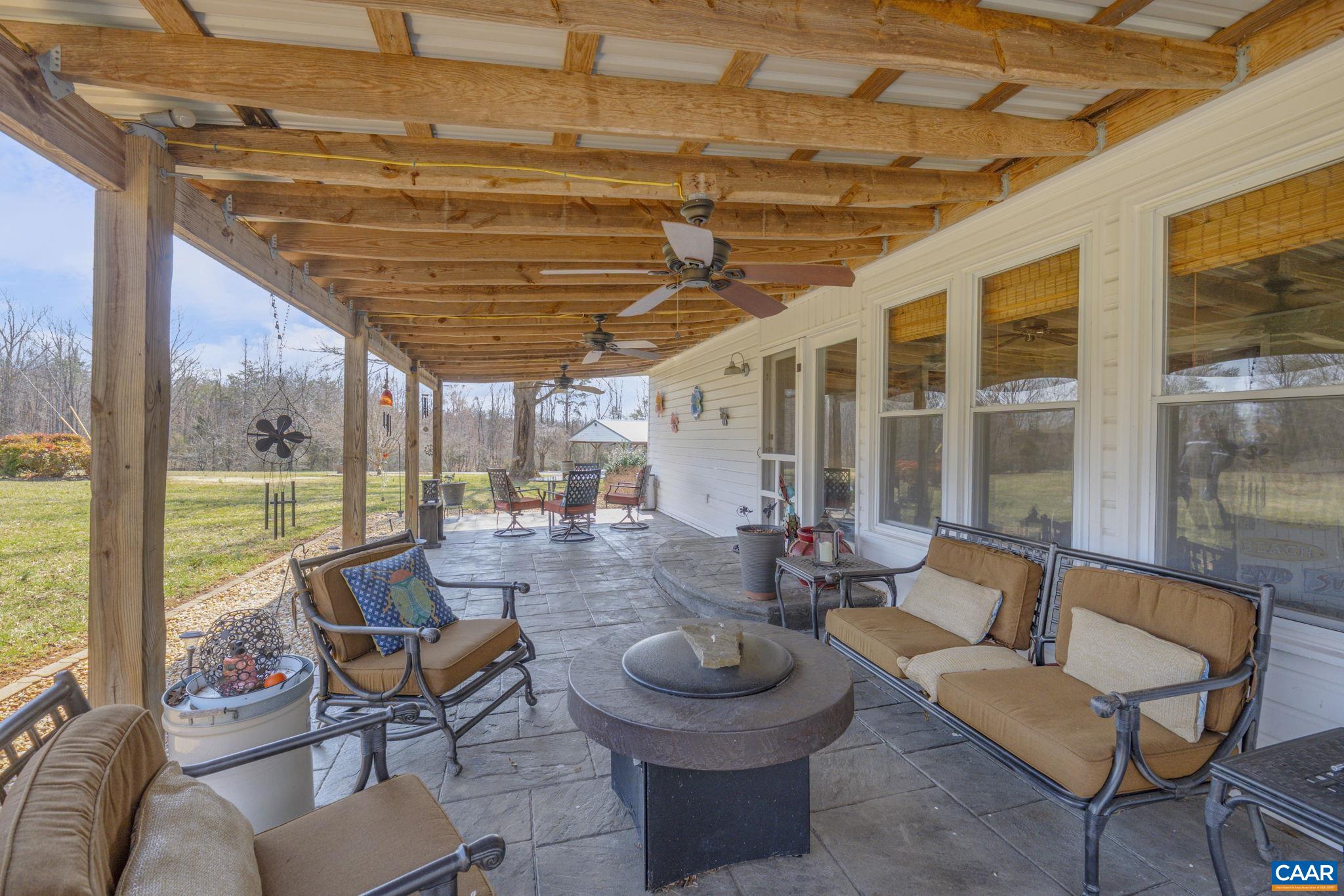 1353 Banton Shop Road Dillwyn, VA 23936 - Photo 32 of 57 a outdoor space with patio the couches and dining table with the view of the swimming pool