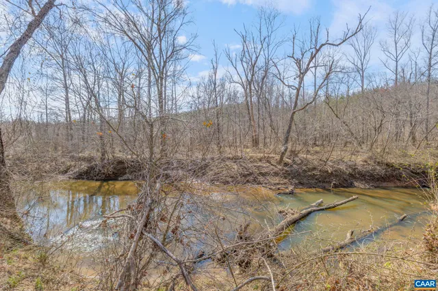 a view of a yard with wooden fence