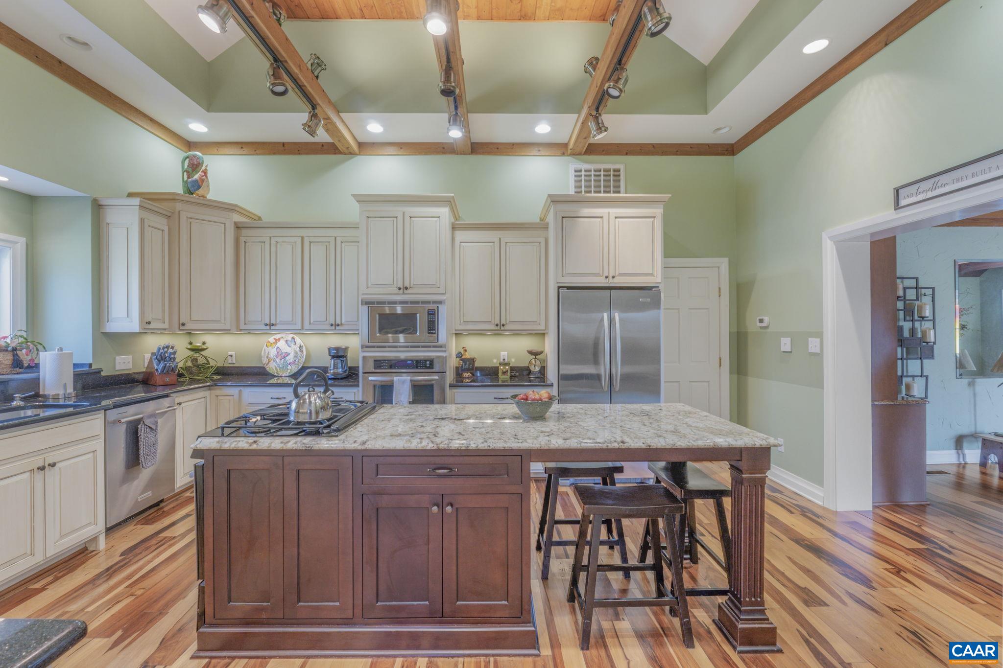 1353 Banton Shop Road Dillwyn, VA 23936 - Photo 7 of 57 a kitchen with kitchen island granite countertop a table chairs sink and cabinets