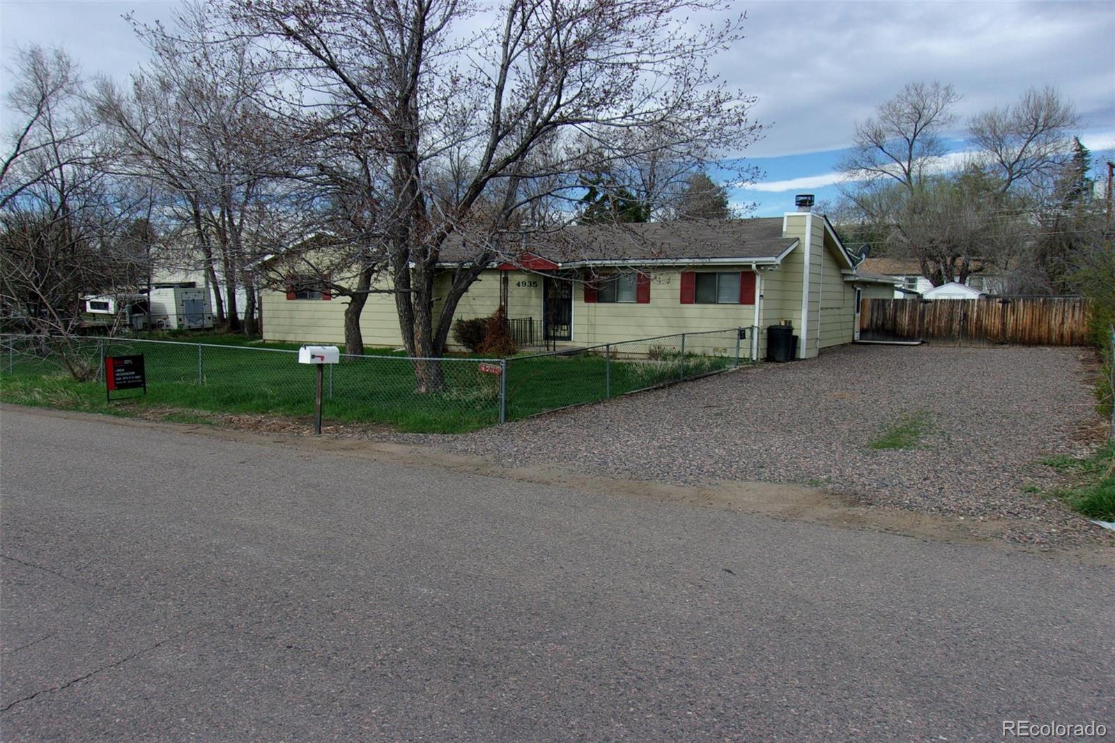 4935 Howell Street Golden, CO 80403 - Photo 1 of 34 a front view of a house with a yard and trees