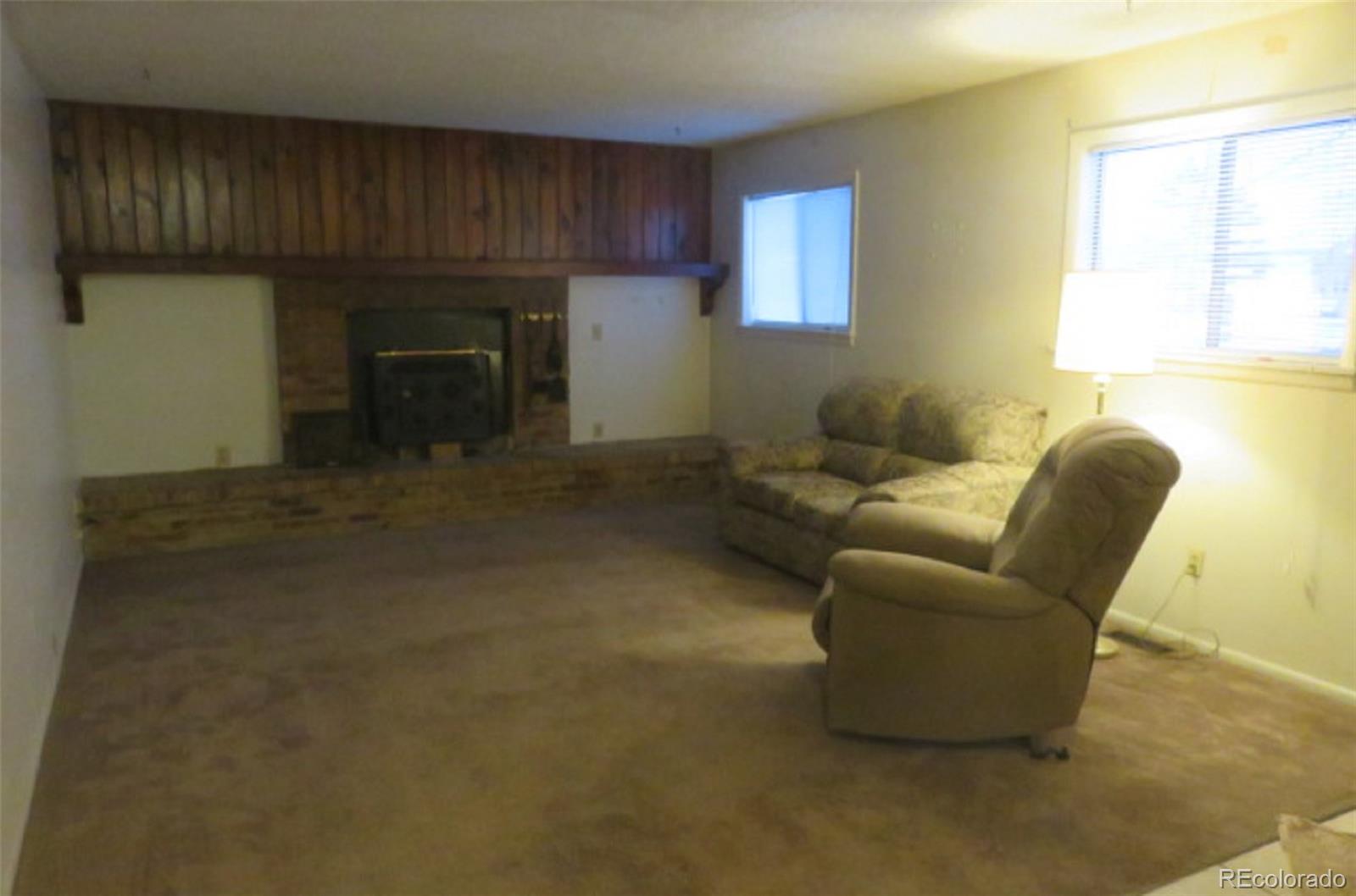 4935 Howell Street Golden, CO 80403 - Photo 11 of 34 a living room with furniture and a fireplace