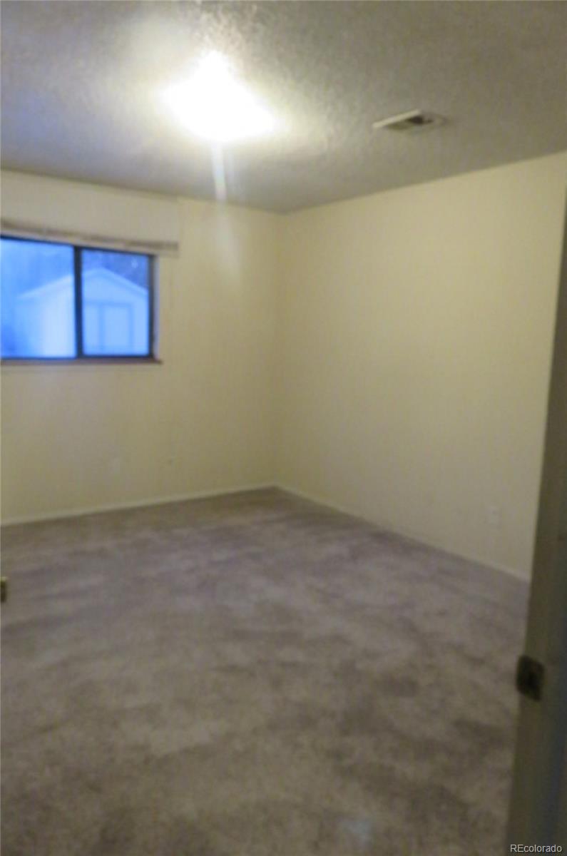4935 Howell Street Golden, CO 80403 - Photo 14 of 34 an empty room with a workbench