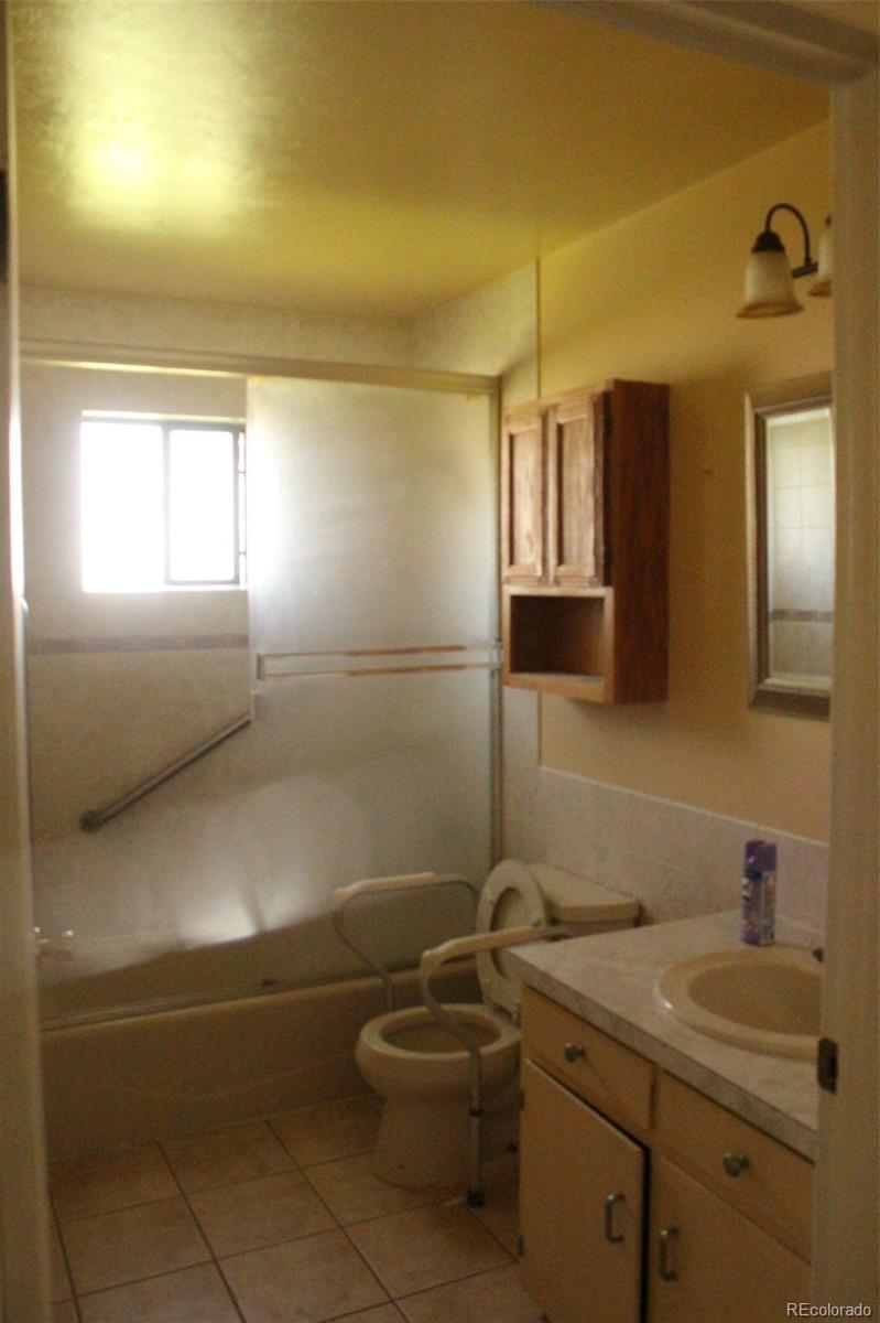4935 Howell Street Golden, CO 80403 - Photo 18 of 34 a bathroom with a sink a toilet and mirror