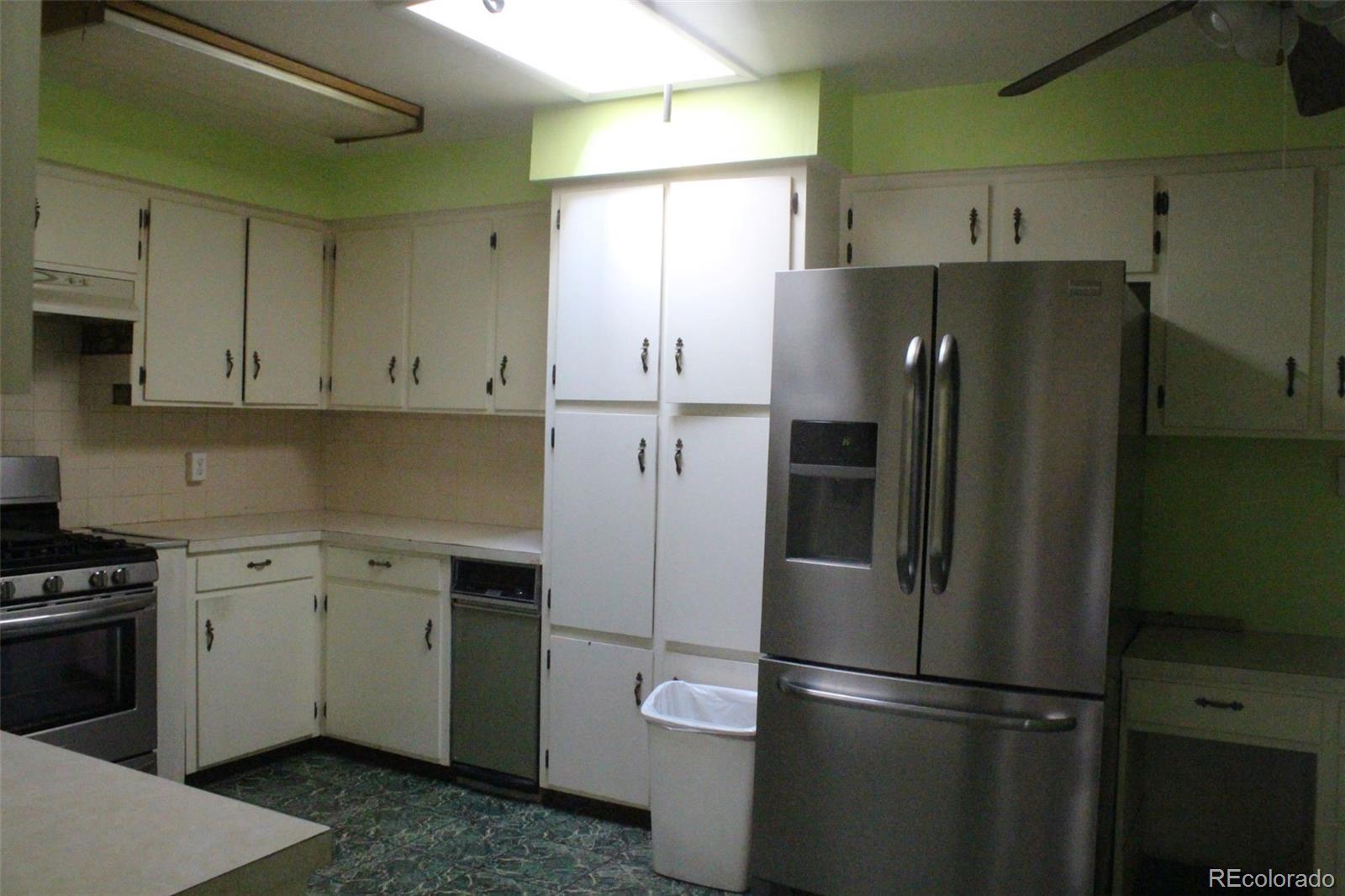 4935 Howell Street Golden, CO 80403 - Photo 25 of 34 a kitchen with stainless steel appliances a refrigerator sink and cabinets