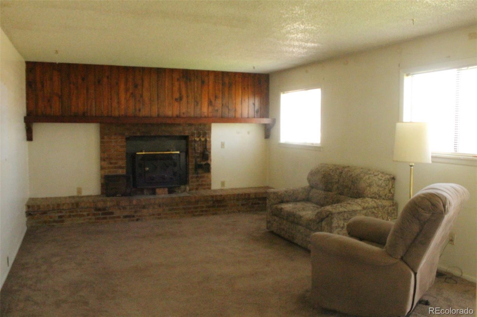 4935 Howell Street Golden, CO 80403 - Photo 27 of 34 a living room with furniture and a fireplace