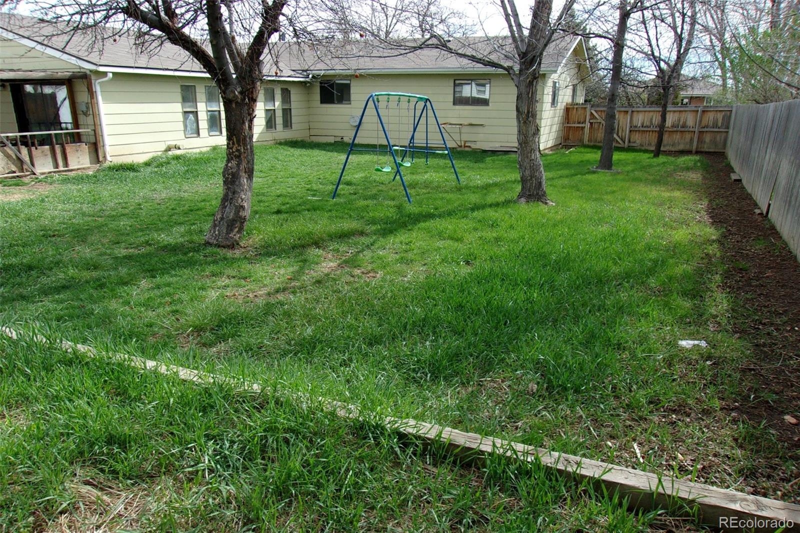 4935 Howell Street Golden, CO 80403 - Photo 3 of 34 a view of a backyard with a garden and trees