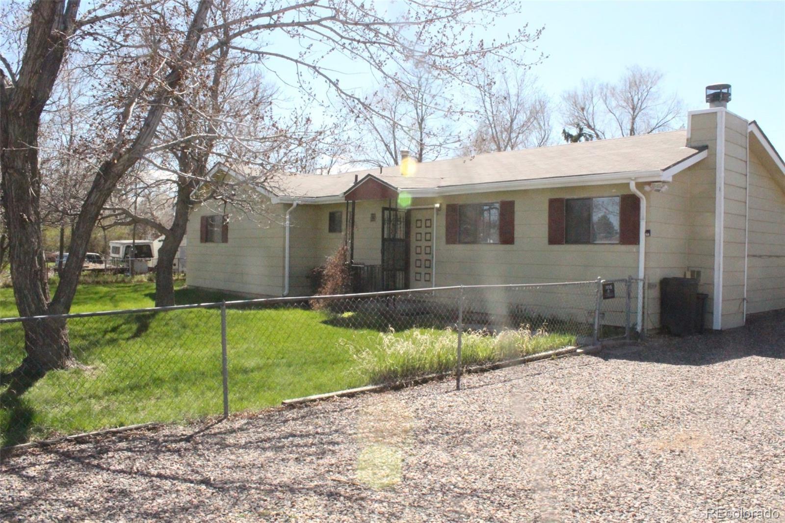 4935 Howell Street Golden, CO 80403 - Photo 32 of 34 a front view of a house with a yard and garage