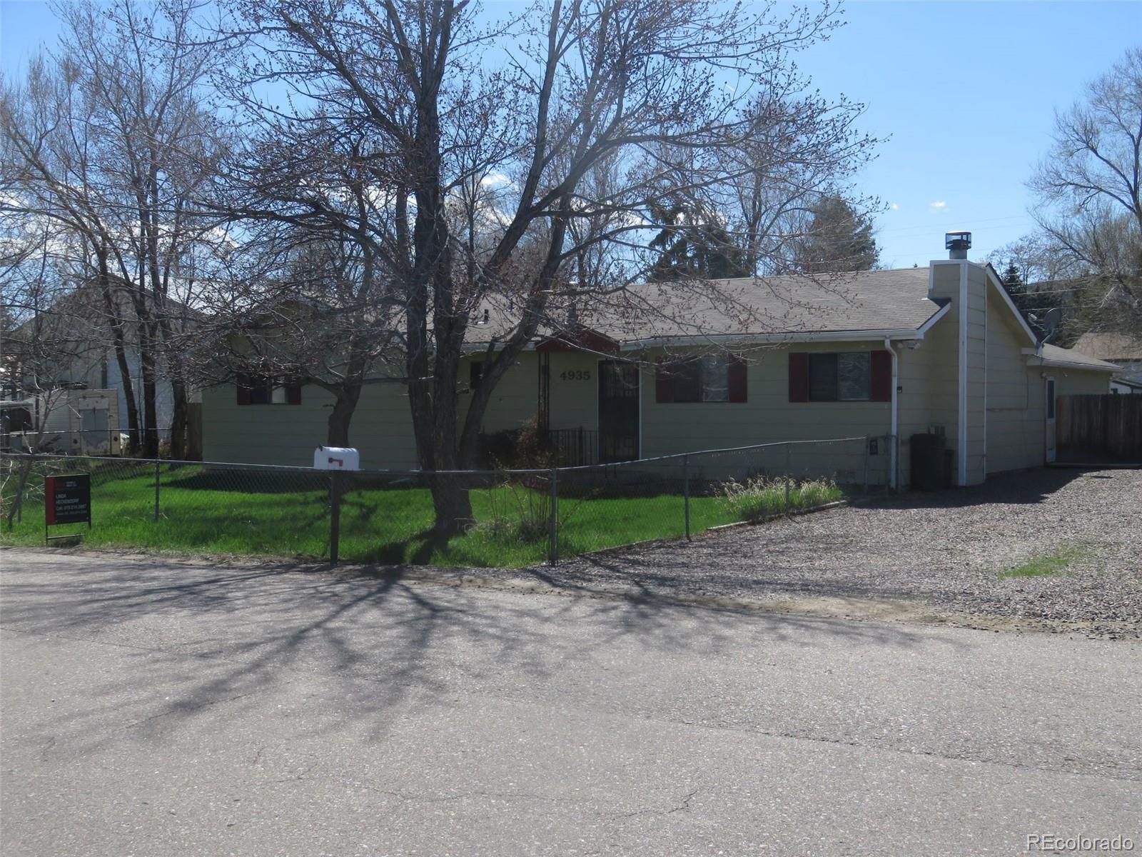 4935 Howell Street Golden, CO 80403 - Photo 33 of 34 a view of a house with a yard and large tree