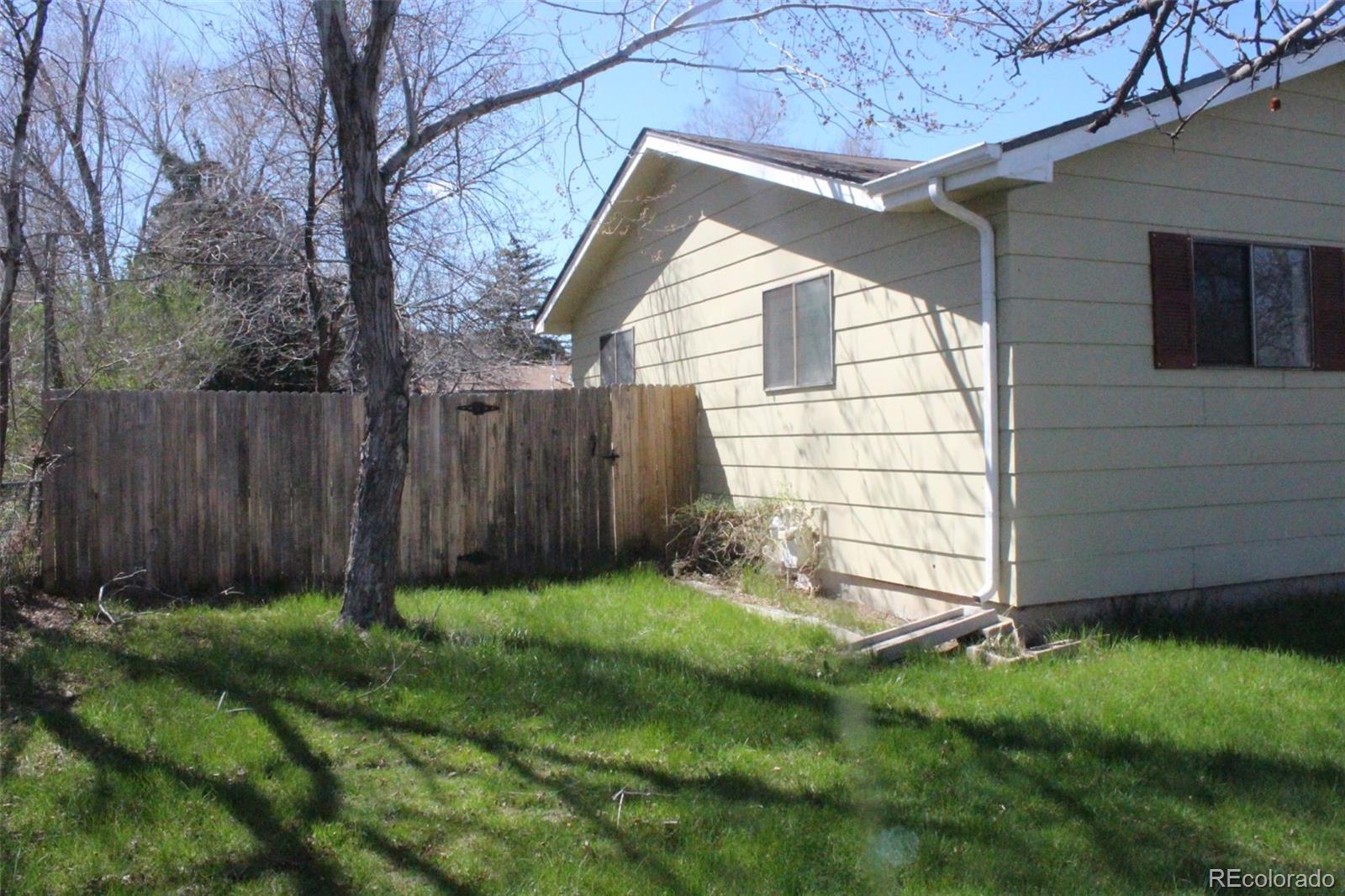 4935 Howell Street Golden, CO 80403 - Photo 7 of 34 a view of backyard with potted plants and a wooden fence