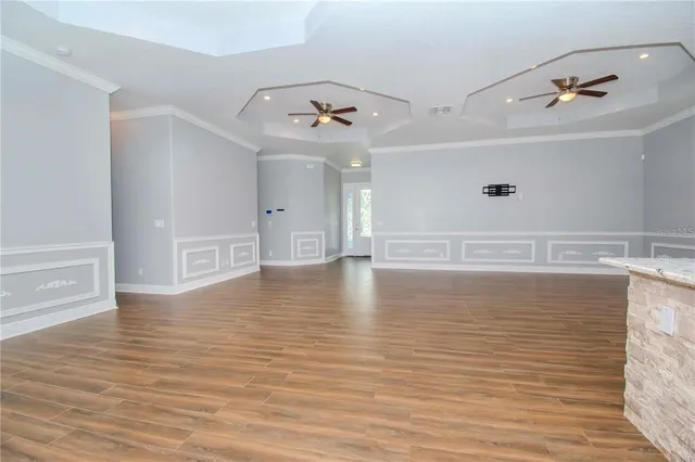 a view of a room with wooden floor