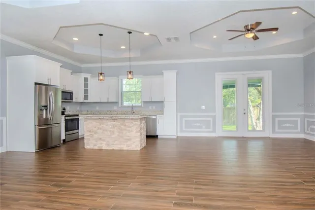 a view of kitchen with cabinets and wooden floor