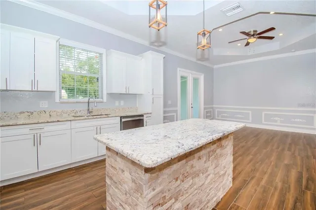 a kitchen with a stove window and cabinets