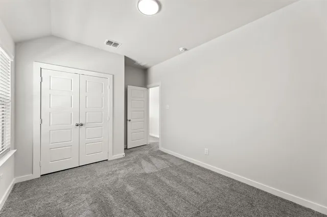 an empty room with closet area