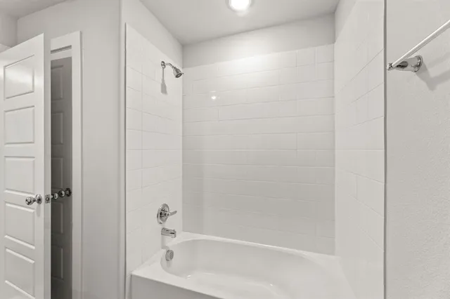 a bathroom with a shower and a bath tub