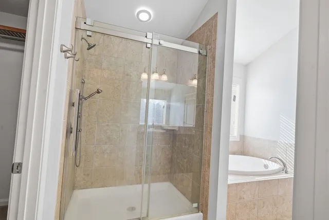 a bathroom with a shower and a tub