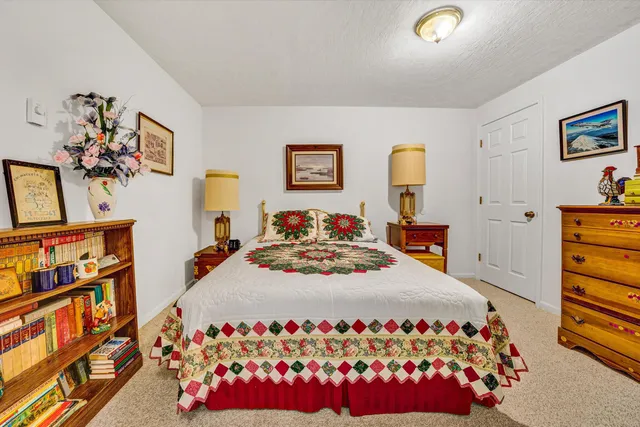 a view of a house with a big yard and large trees
