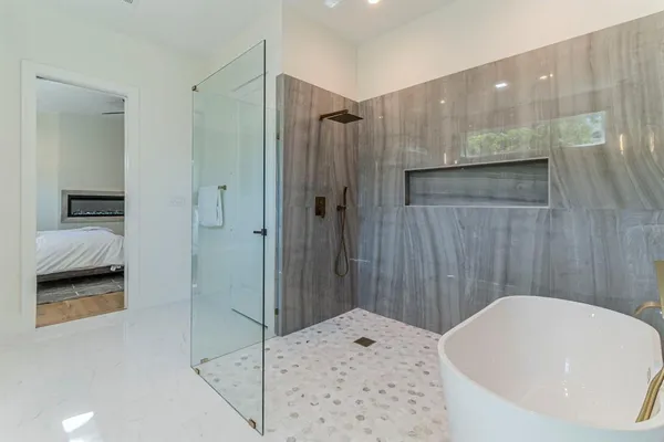 a bathroom with a bathtub and a shower