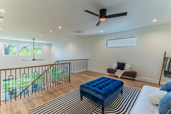 a living room with furniture a rug and a wooden floor