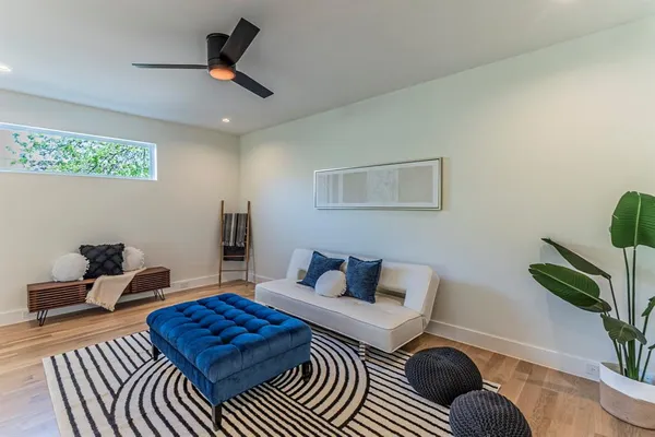 a living room with furniture rug and wooden floor