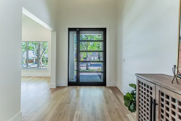 a view of hallway with furniture and wooden floor