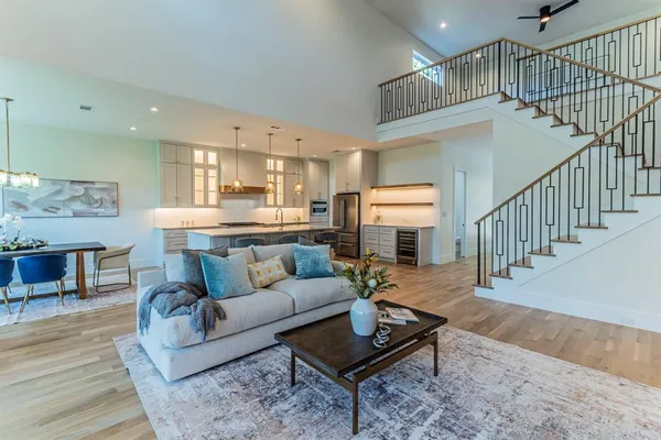 a living room with furniture and a dining table
