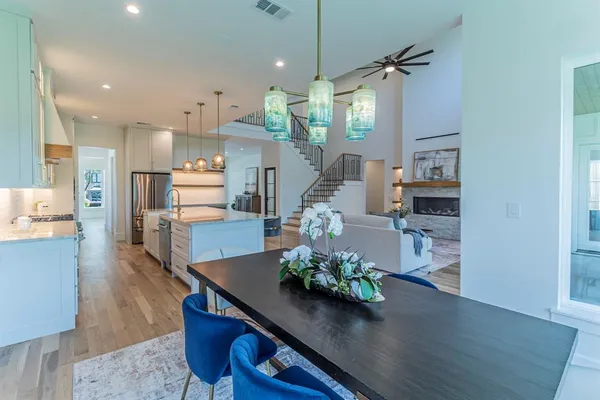 a living room with kitchen island furniture and a chandelier