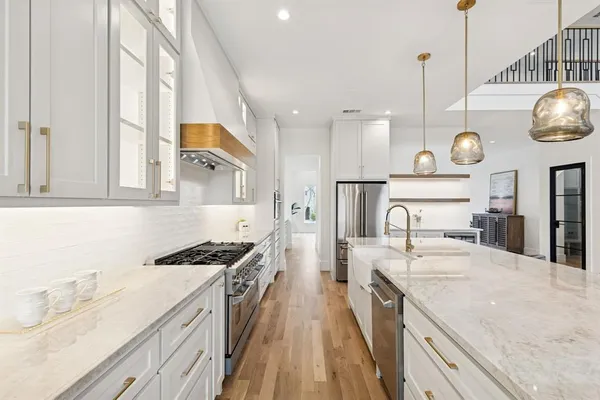 a kitchen with a sink stove and cabinets