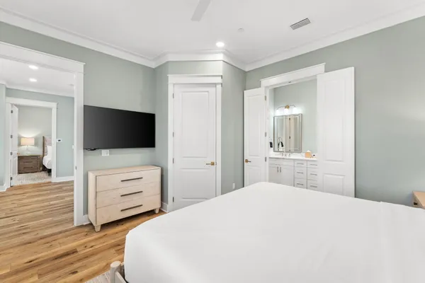 a bedroom with a bed and flat screen tv