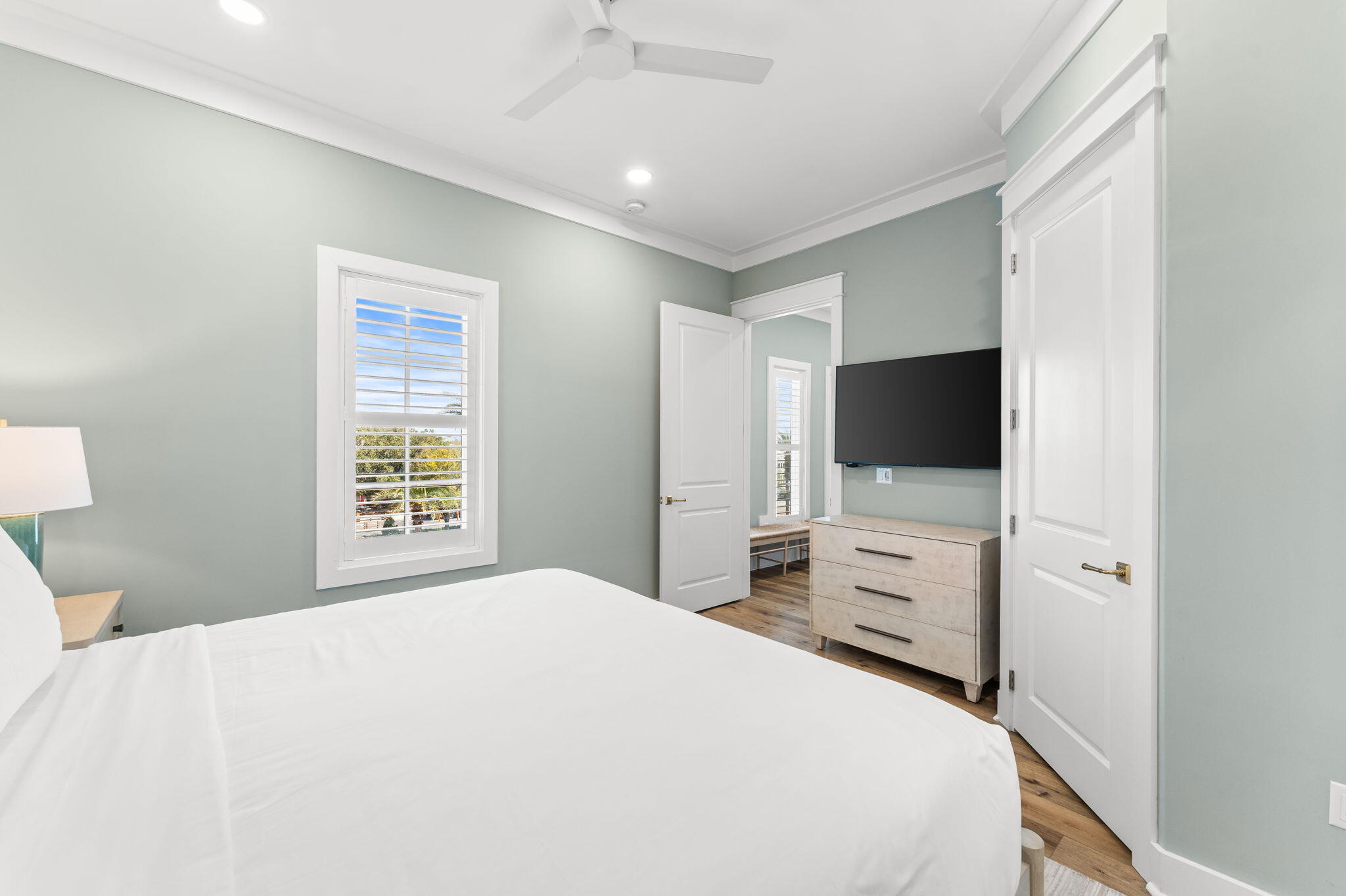 413 Henderson Cottage Way Destin, FL 32541 - Photo 20 of 48 a bedroom with a bed and a flat tv screen on dresser