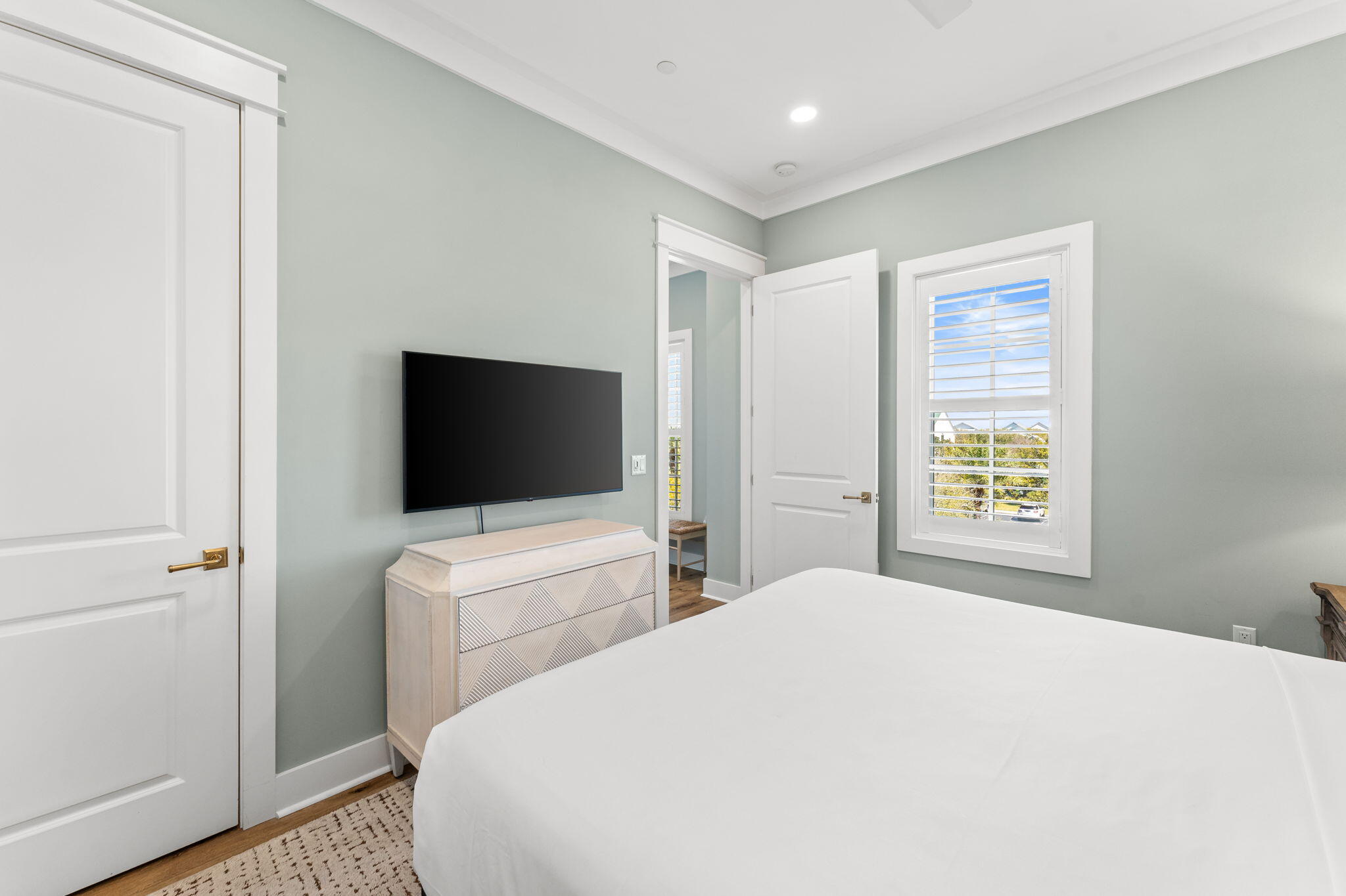 413 Henderson Cottage Way Destin, FL 32541 - Photo 24 of 48 a bedroom with a bed and a flat screen tv