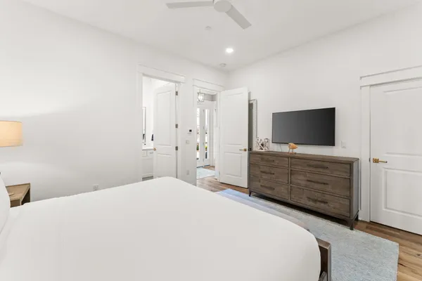 a bedroom with a bed and flat screen tv