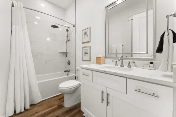 a bathroom with a sink a toilet and a large mirror