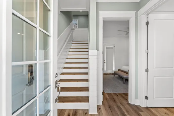 a view of a hallway with wooden floor and entryway