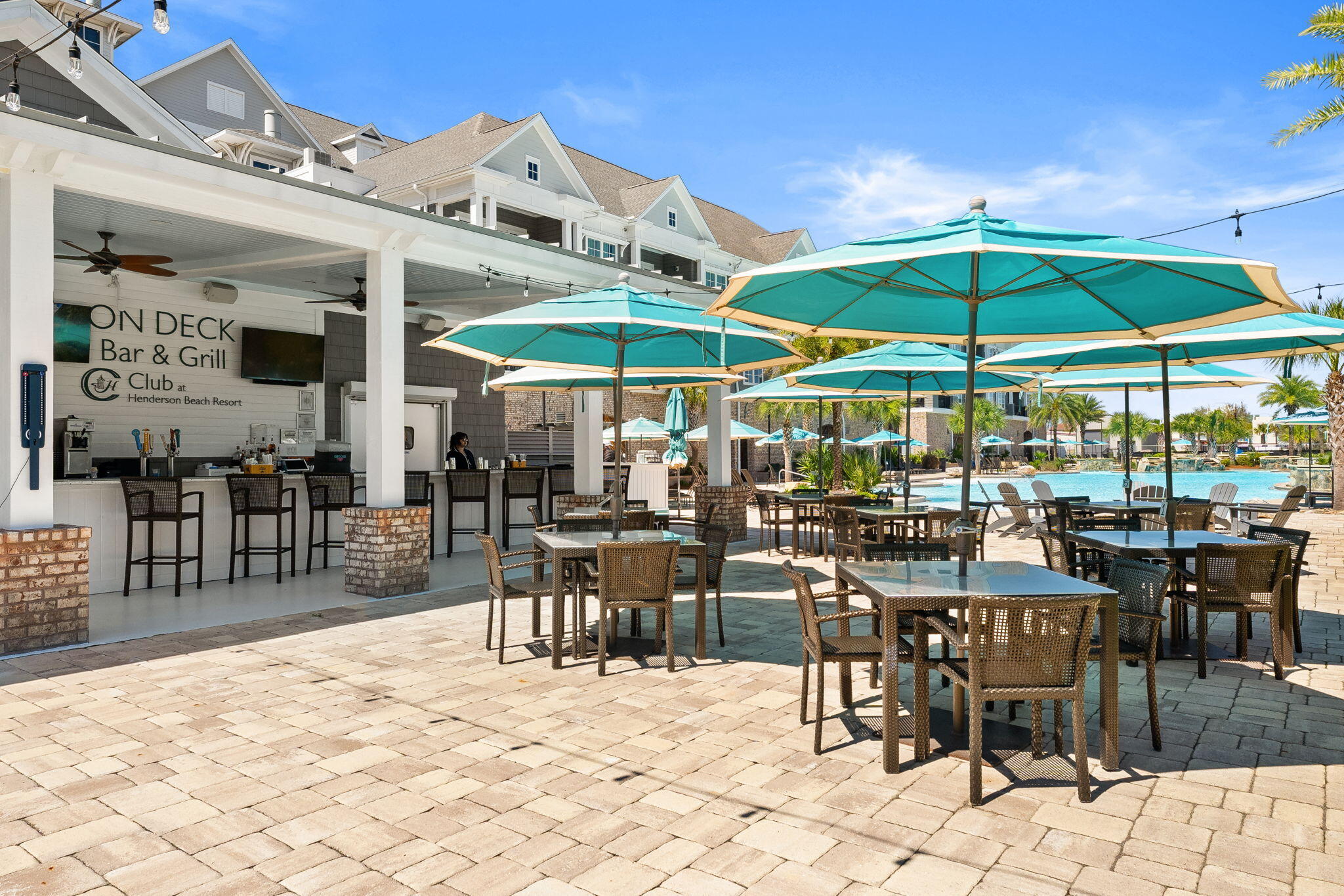 413 Henderson Cottage Way Destin, FL 32541 - Photo 44 of 48 a view of a patio with a dining table and chairs under an umbrella