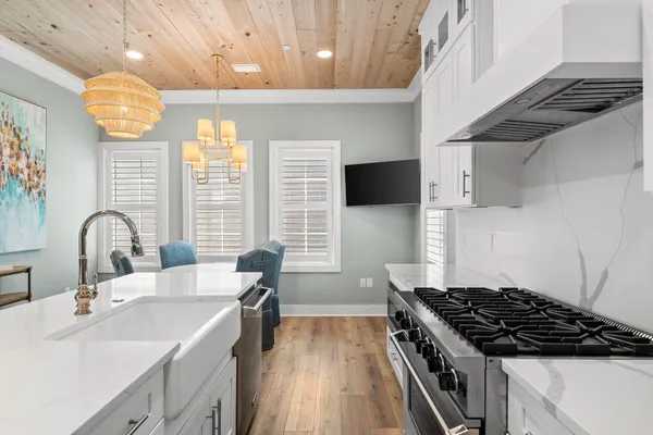a kitchen with kitchen island a sink stainless steel appliances a counter space and a window