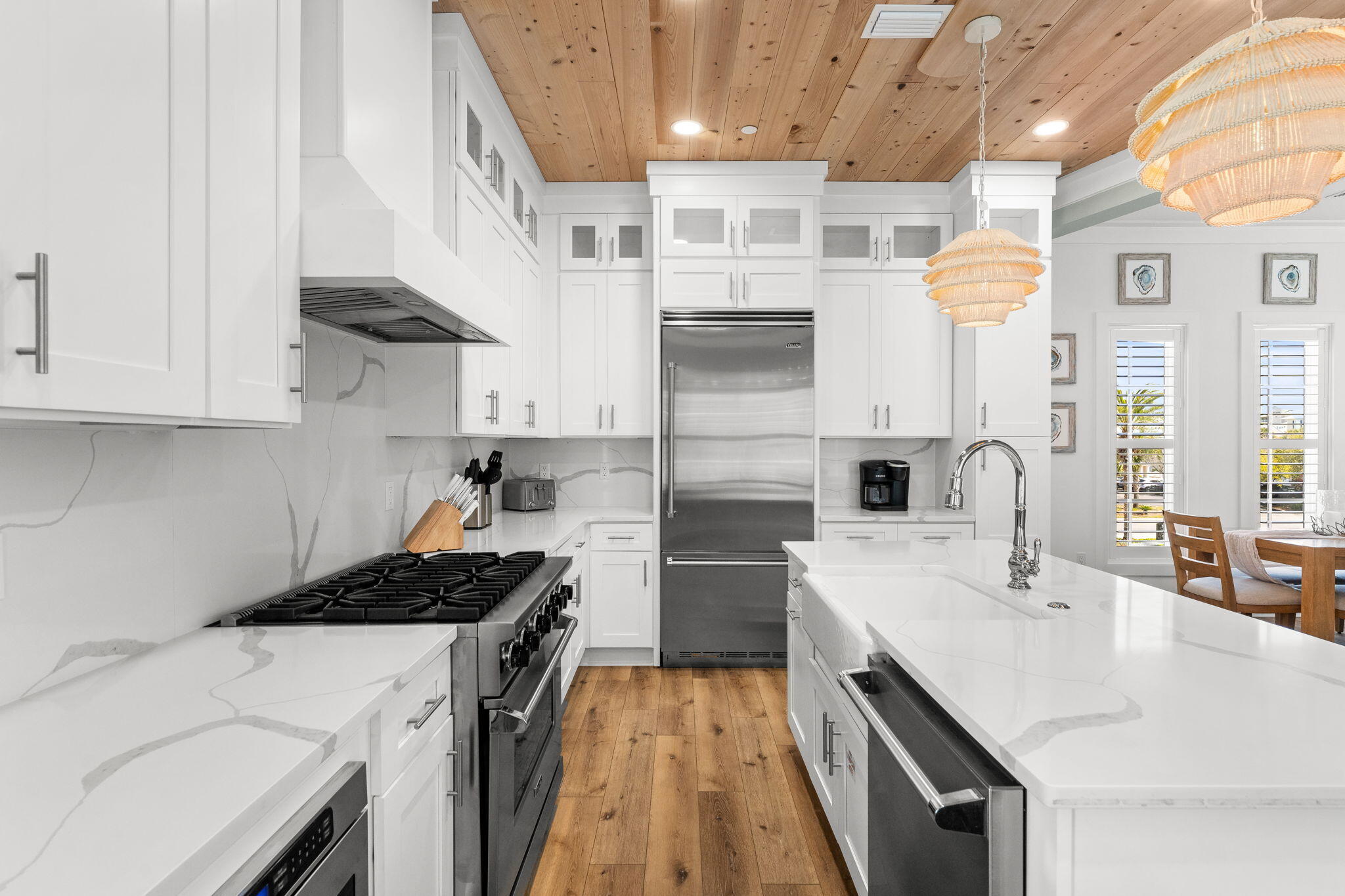 413 Henderson Cottage Way Destin, FL 32541 - Photo 8 of 48 a kitchen that has a lot of cabinets in it and wooden floors