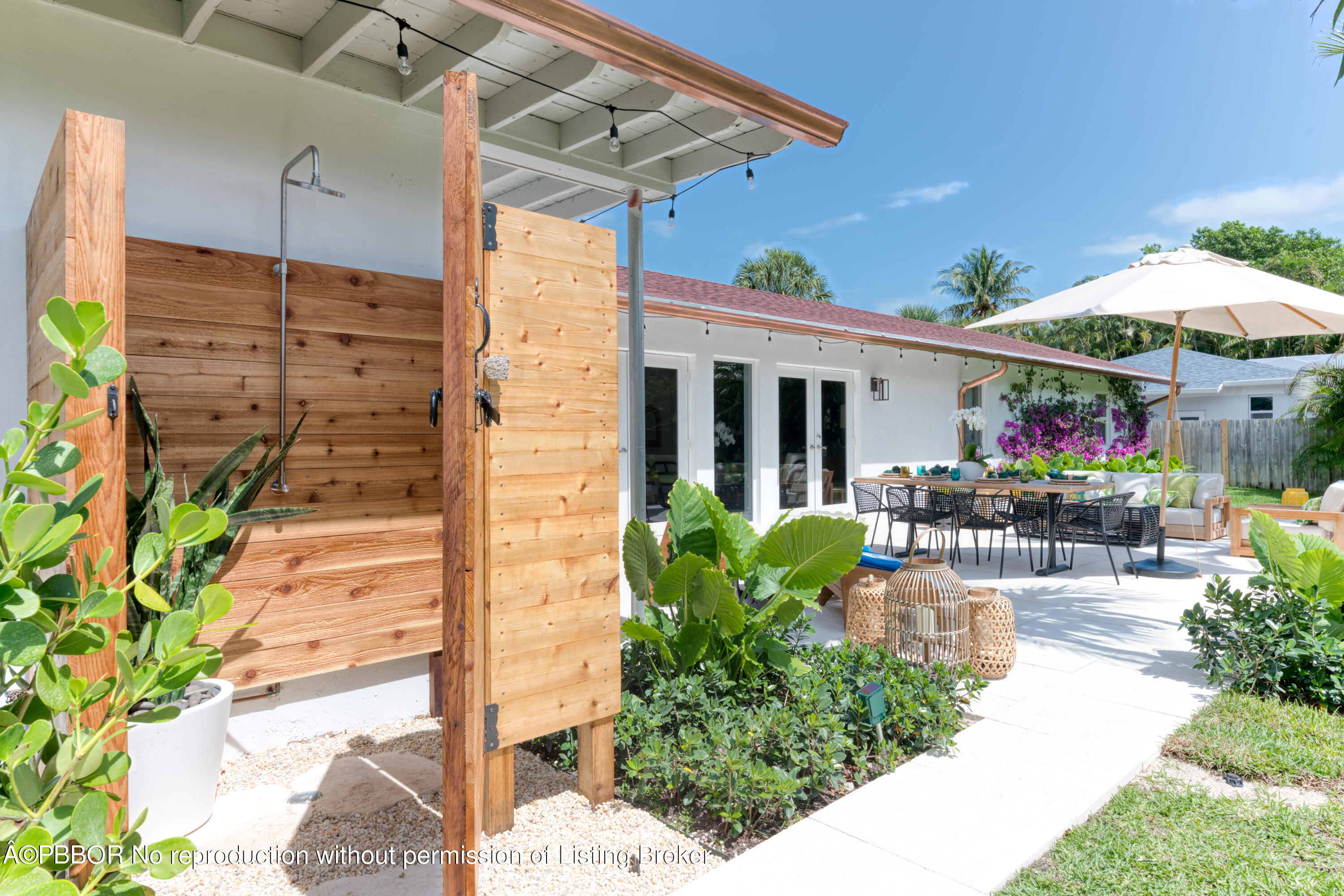 222 Pilgrim Road West Palm Beach, FL 33405 - Photo 11 of 12 a view of a patio with table and chairs under an umbrella