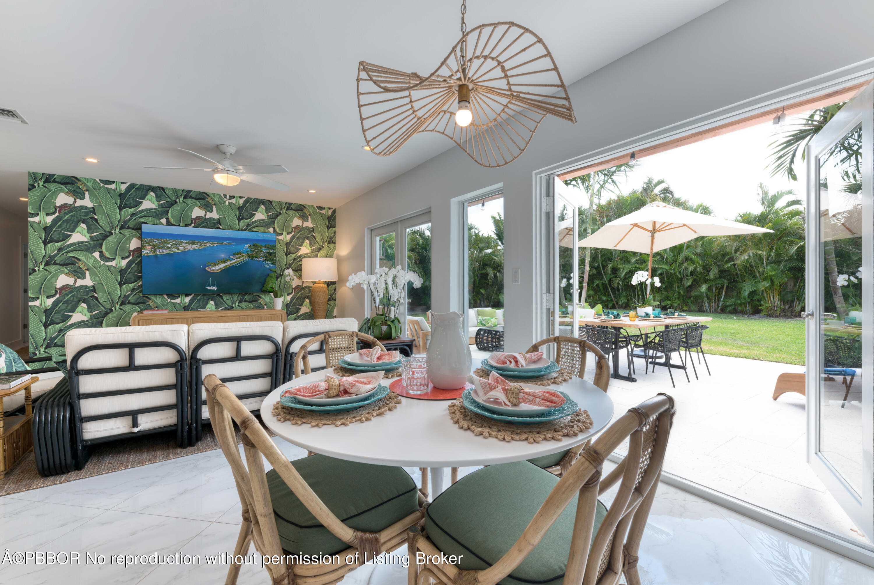 222 Pilgrim Road West Palm Beach, FL 33405 - Photo 4 of 12 a view of a dining room with furniture large windows and garden view