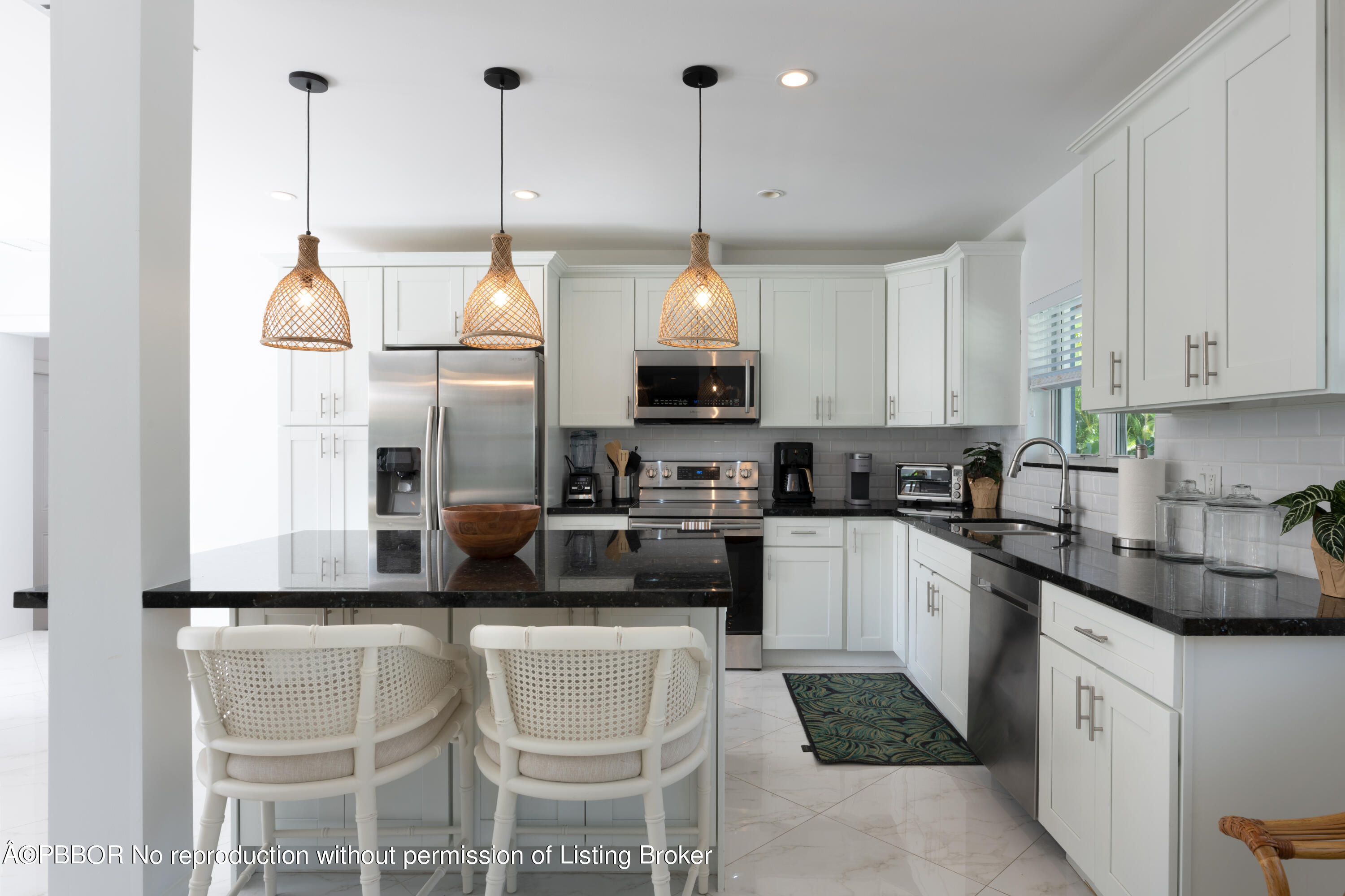 222 Pilgrim Road West Palm Beach, FL 33405 - Photo 5 of 12 a kitchen with kitchen island granite countertop a stove a sink and a refrigerator