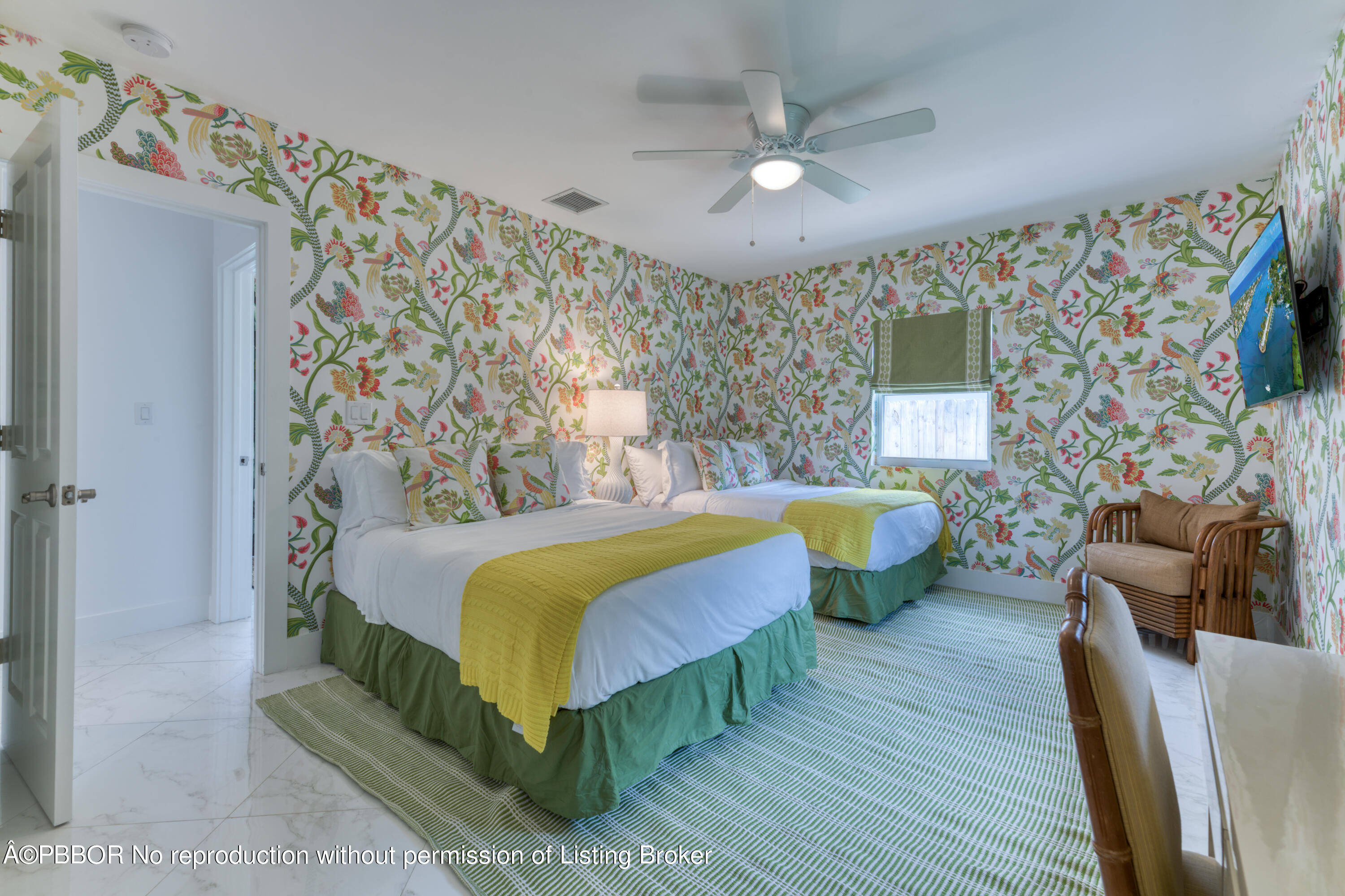 222 Pilgrim Road West Palm Beach, FL 33405 - Photo 8 of 12 a bedroom with a bed a couch and a flat screen tv
