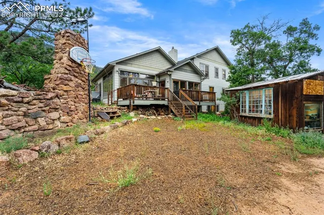 a living room with granite countertop furniture a fireplace and a flat screen tv