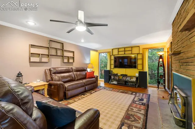 a view of a dining room with furniture a chandelier and wooden floor