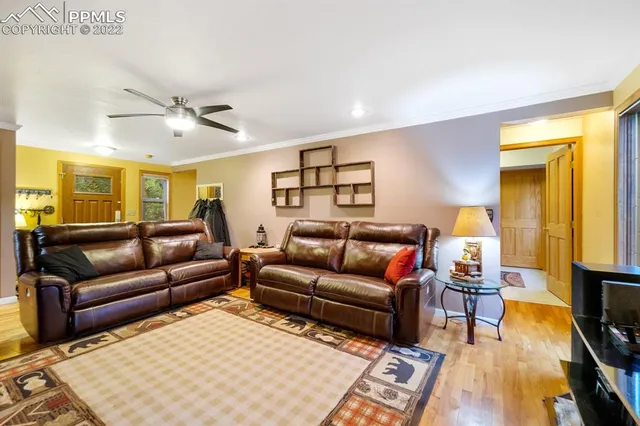 a view of a dining room with furniture large windows and wooden floor