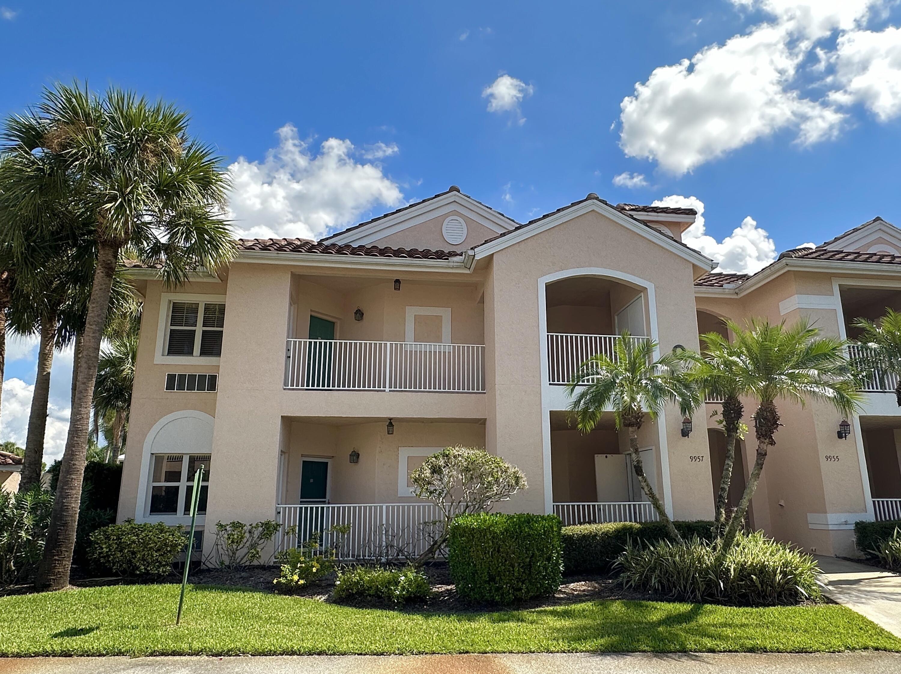 9969 Perfect Drive, Unit 164 Port St. Lucie, FL 34986 - Photo 1 of 52 a front view of a house with a yard and garage
