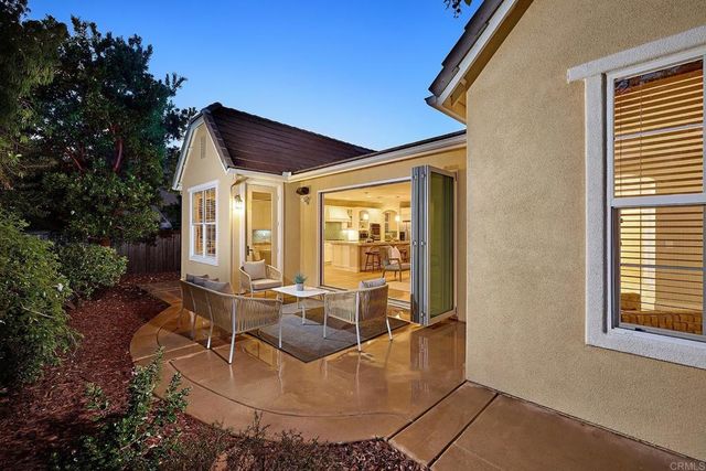 a building outdoor space with patio furniture and potted plants