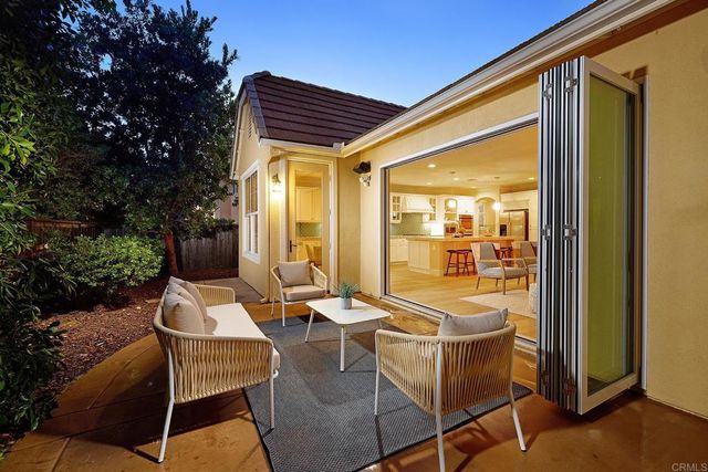a patio with yard glass top table and chairs