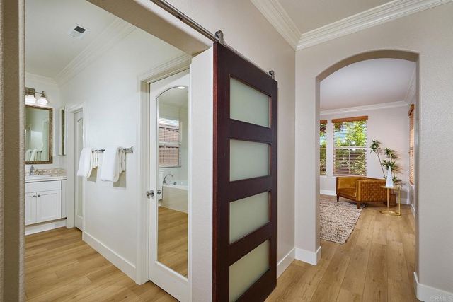 a view of a hallway view with wooden floor and furniture