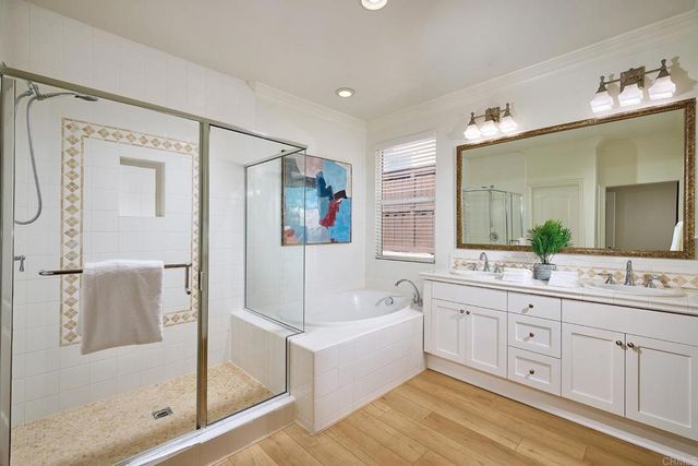 a spacious bathroom with a tub sink shower and mirror