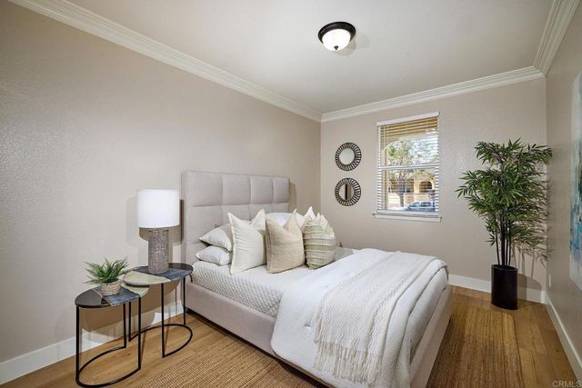 a bedroom with a bed and a potted plant