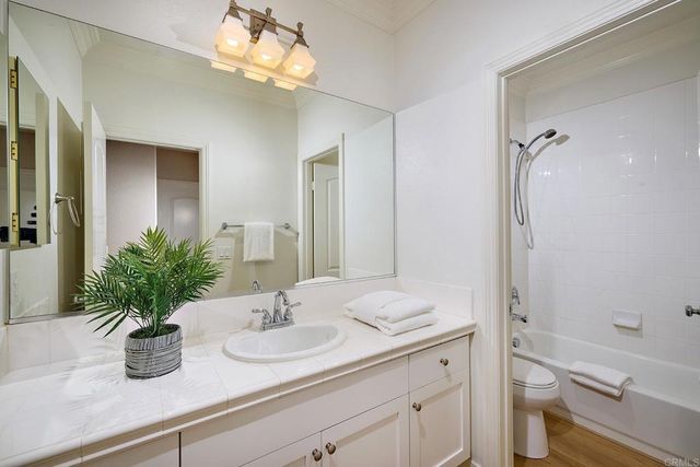 a bathroom with a sink a vanity and a mirror